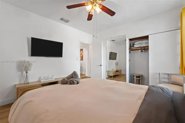a bedroom with a bed and a flat screen tv