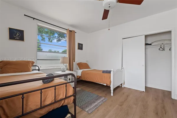 a bedroom with furniture and wooden floor