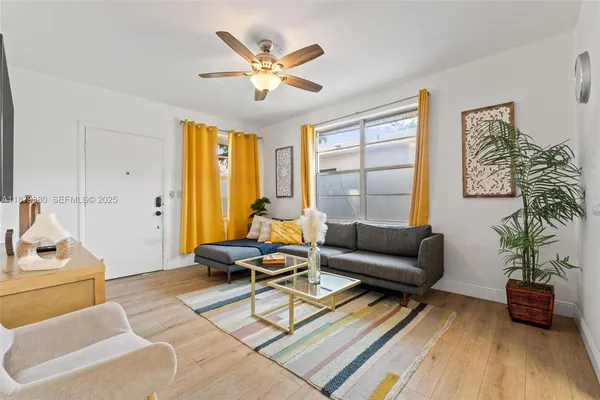 a living room with furniture and wooden floor