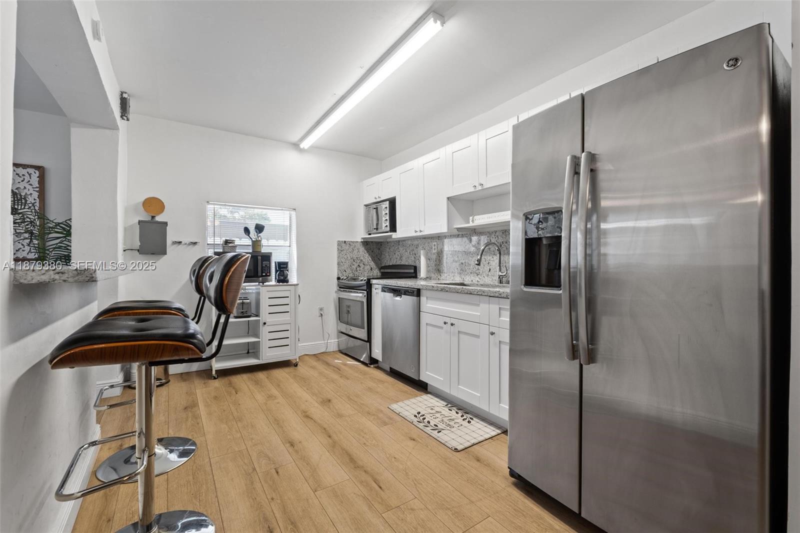2453 Southwest 17th Street, Unit 2453 Miami, FL 33145 - Photo 8 of 22 a kitchen with stainless steel appliances a refrigerator and a sink