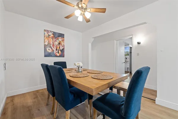 a view of a dining room with furniture and wooden floor