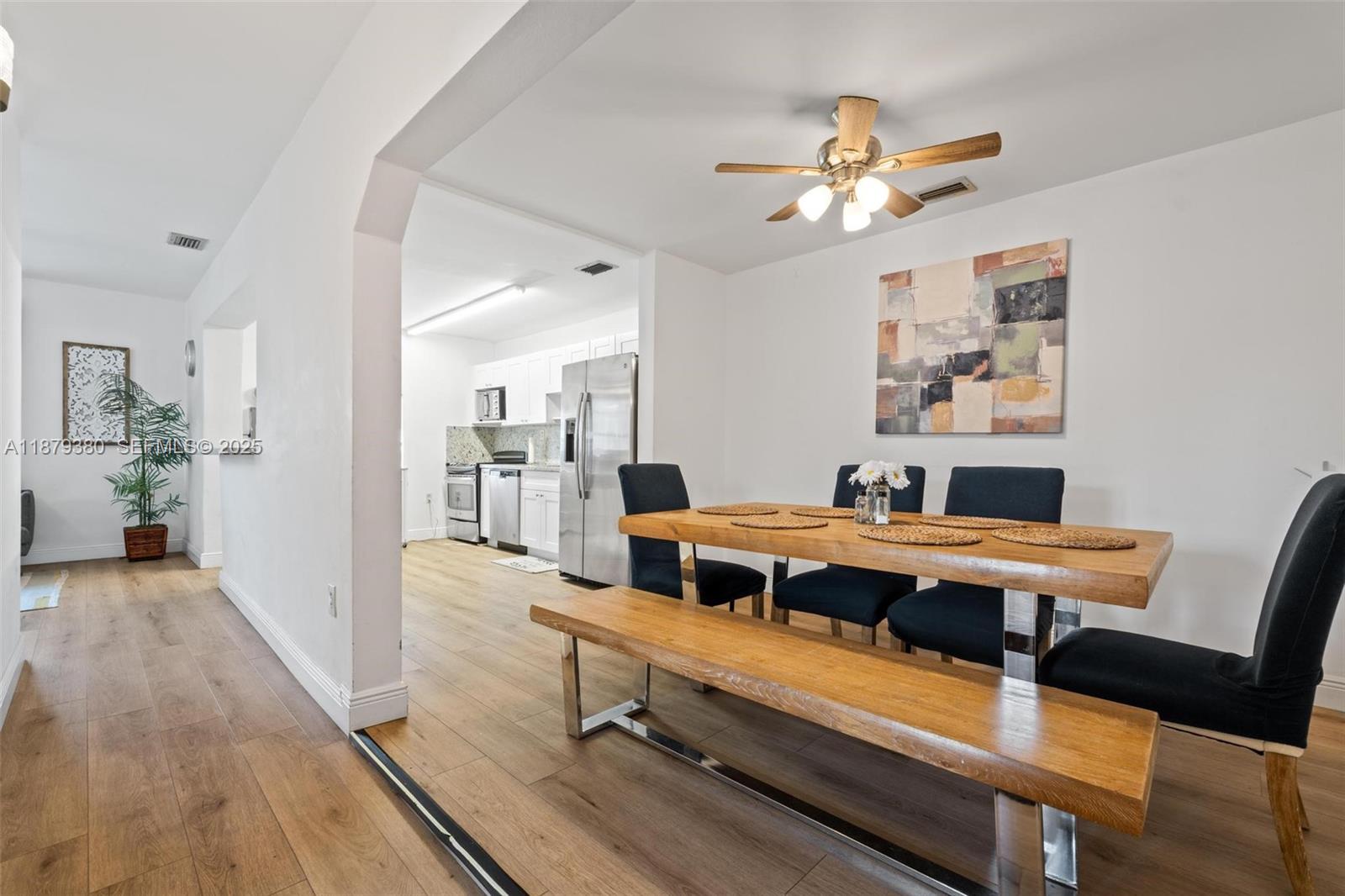 2453 Southwest 17th Street, Unit 2453 Miami, FL 33145 - Photo 10 of 22 a room with a table chairs and wooden floor