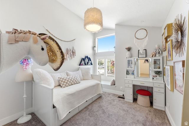7935 Mustang Loop Road Park City, UT 84098 - Photo 45 of 60 Vaulted ceiling with a contemporary pendant light fixture, featuring a built-in daybed with integrated storage drawers, a dressing table with cabinet storage, a window seat, and large windows with plantation shutters