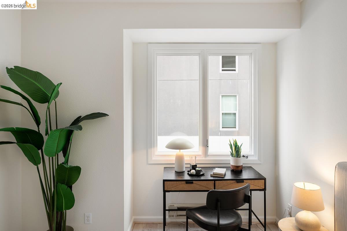 2029 Channing Way, Unit 3D Berkeley, CA 94704 - Photo 45 of 54 Dedicated workspace featuring a window with white trim, light-toned walls, and wood-finish flooring