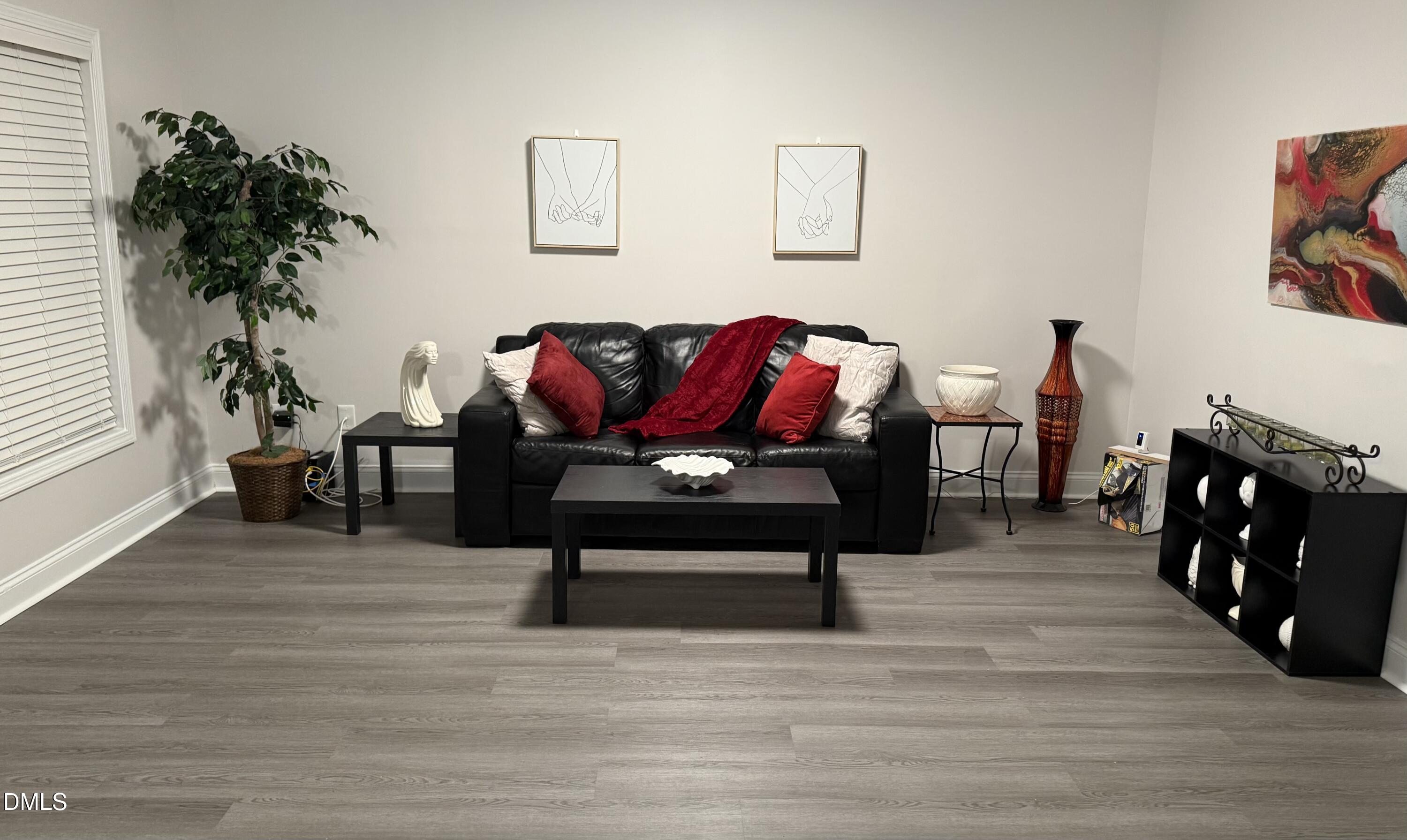 415 Sowell Street Durham, NC 27701 - Photo 10 of 19 a living room with furniture and a potted plant