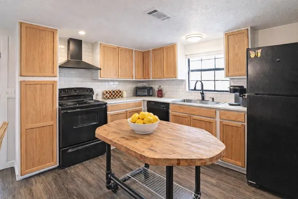 a kitchen with a refrigerator a stove a sink and a refrigerator