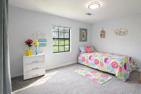 a bedroom with a bed and a dresser