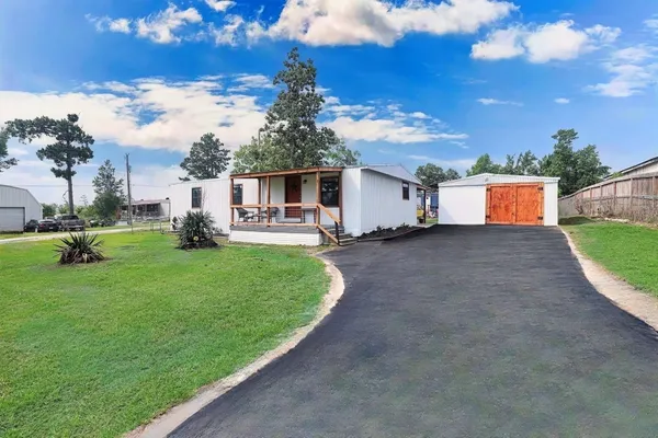 a front view of a house with a yard and sitting area