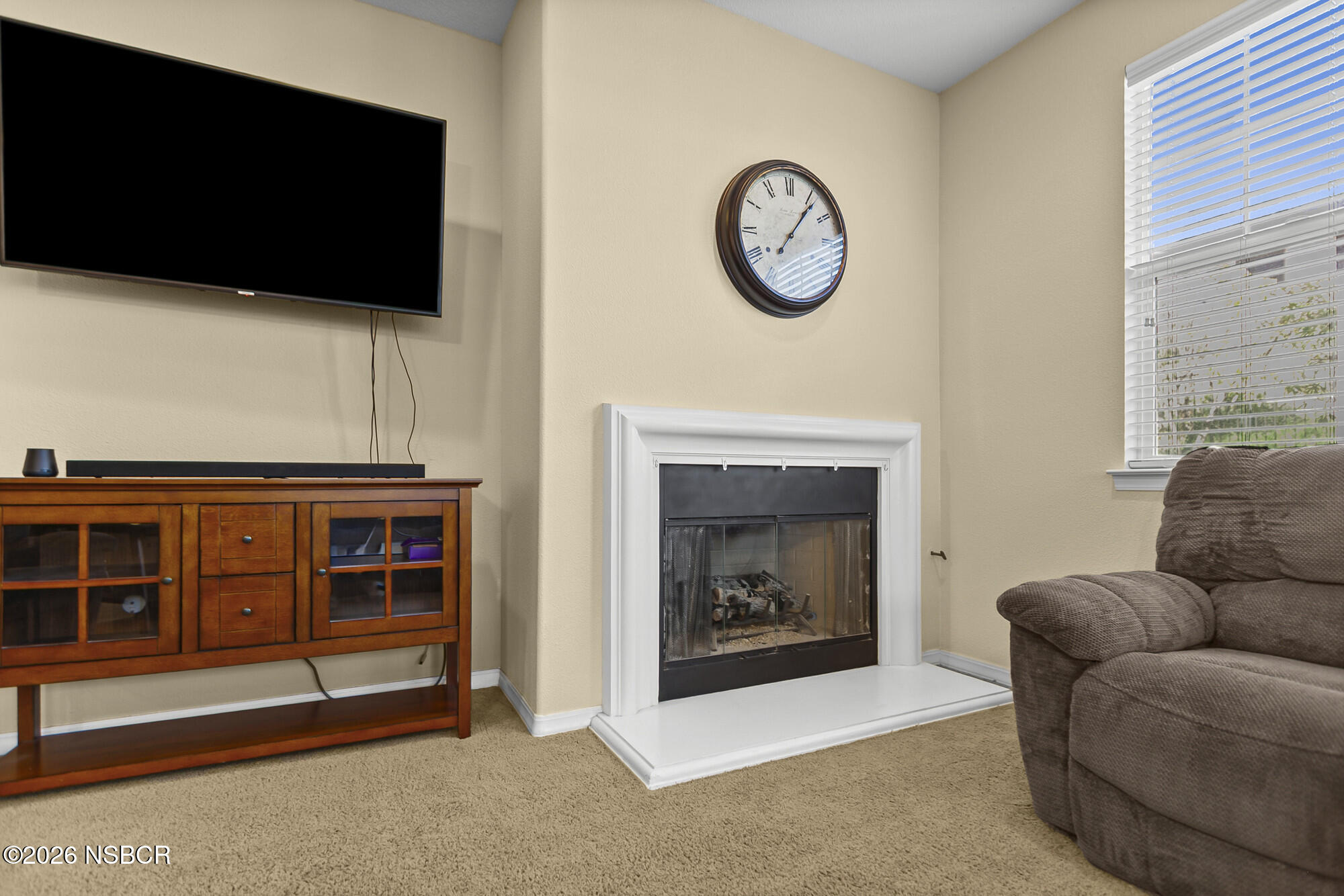 1557 Canyon Creek Road Santa Maria, CA 93455 - Photo 11 of 43 a living room with furniture a flat screen tv and a fireplace