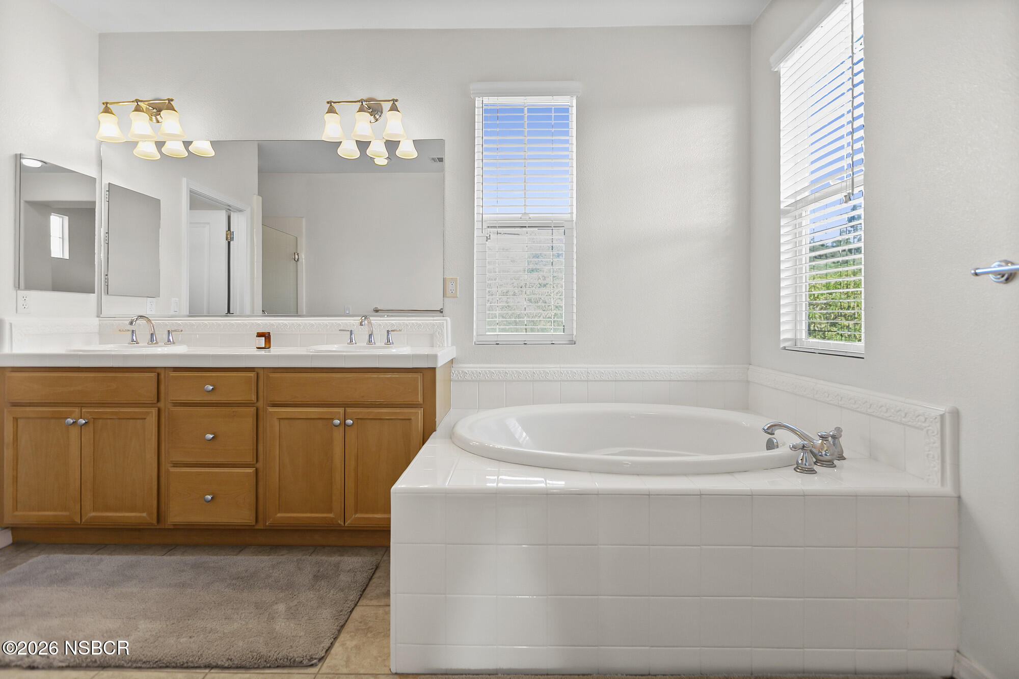 1557 Canyon Creek Road Santa Maria, CA 93455 - Photo 16 of 43 a spacious bathroom with a tub sink and mirror