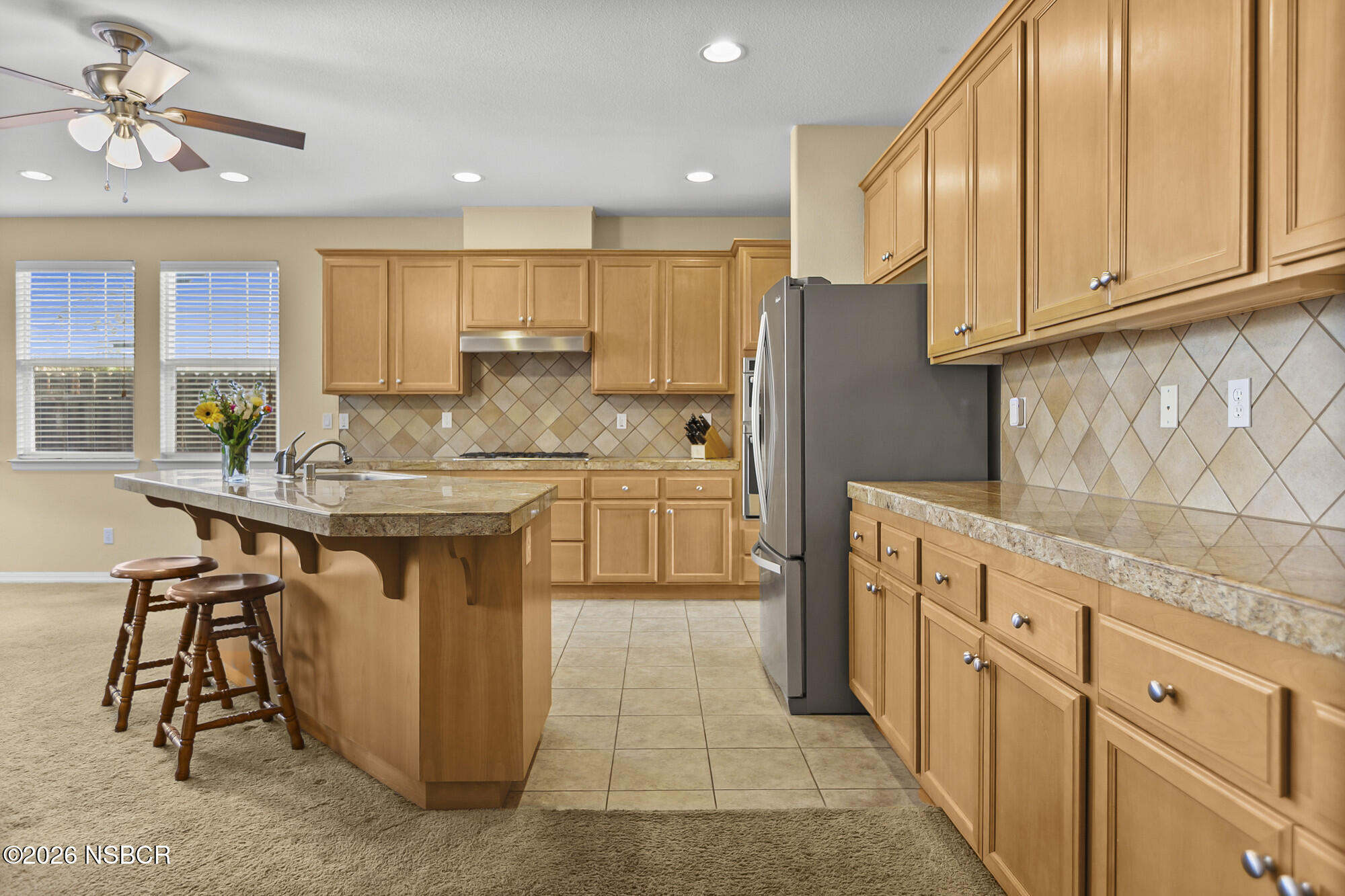 1557 Canyon Creek Road Santa Maria, CA 93455 - Photo 3 of 43 a kitchen with stainless steel appliances granite countertop a sink and a refrigerator