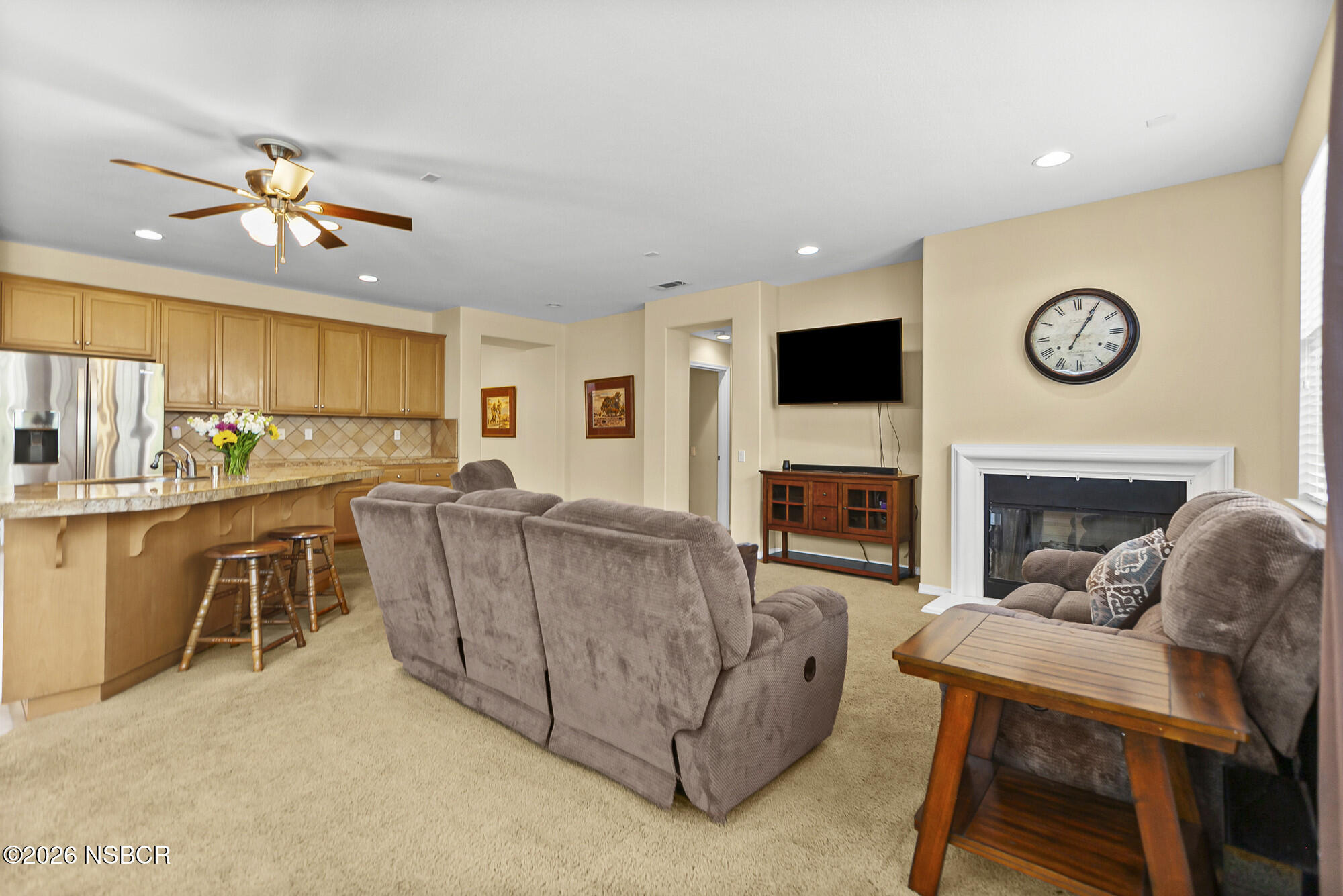 1557 Canyon Creek Road Santa Maria, CA 93455 - Photo 8 of 43 a living room with furniture a flat screen tv and a fireplace