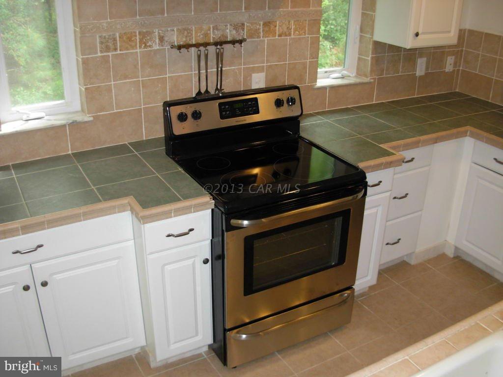 9409 Croppers Island Road Newark, MD 21841 - Photo 12 of 27 a stove top oven sitting inside of a kitchen