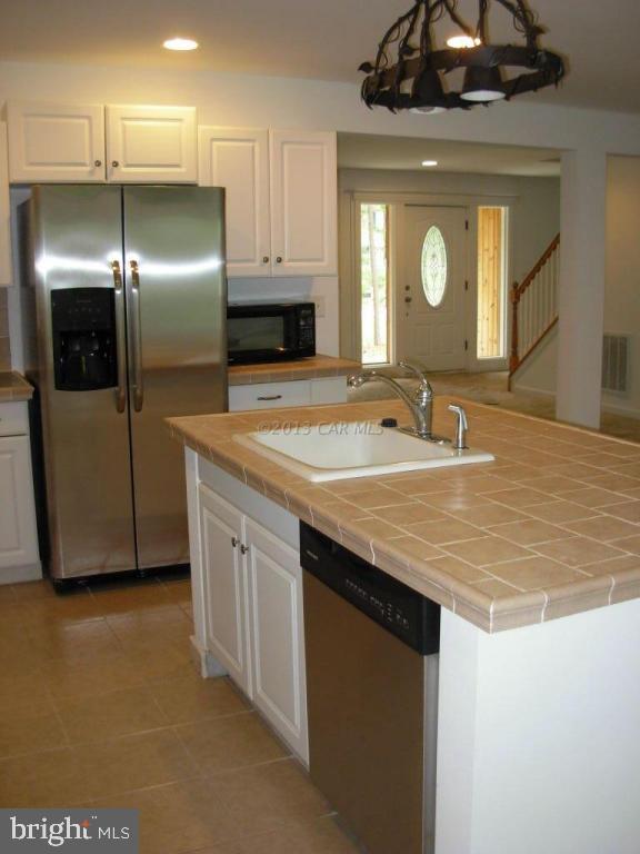 9409 Croppers Island Road Newark, MD 21841 - Photo 14 of 27 a bathroom with a granite countertop sink a toilet and a mirror