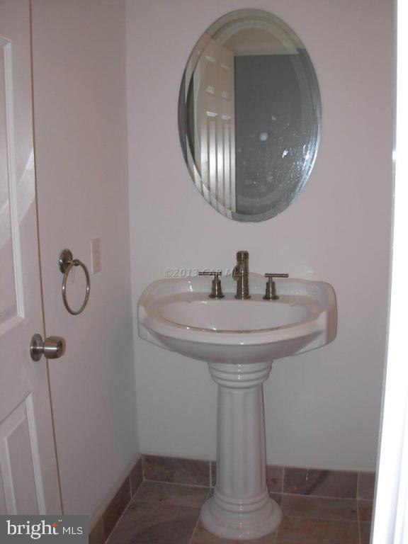 9409 Croppers Island Road Newark, MD 21841 - Photo 26 of 27 a bathroom with a sink and mirror