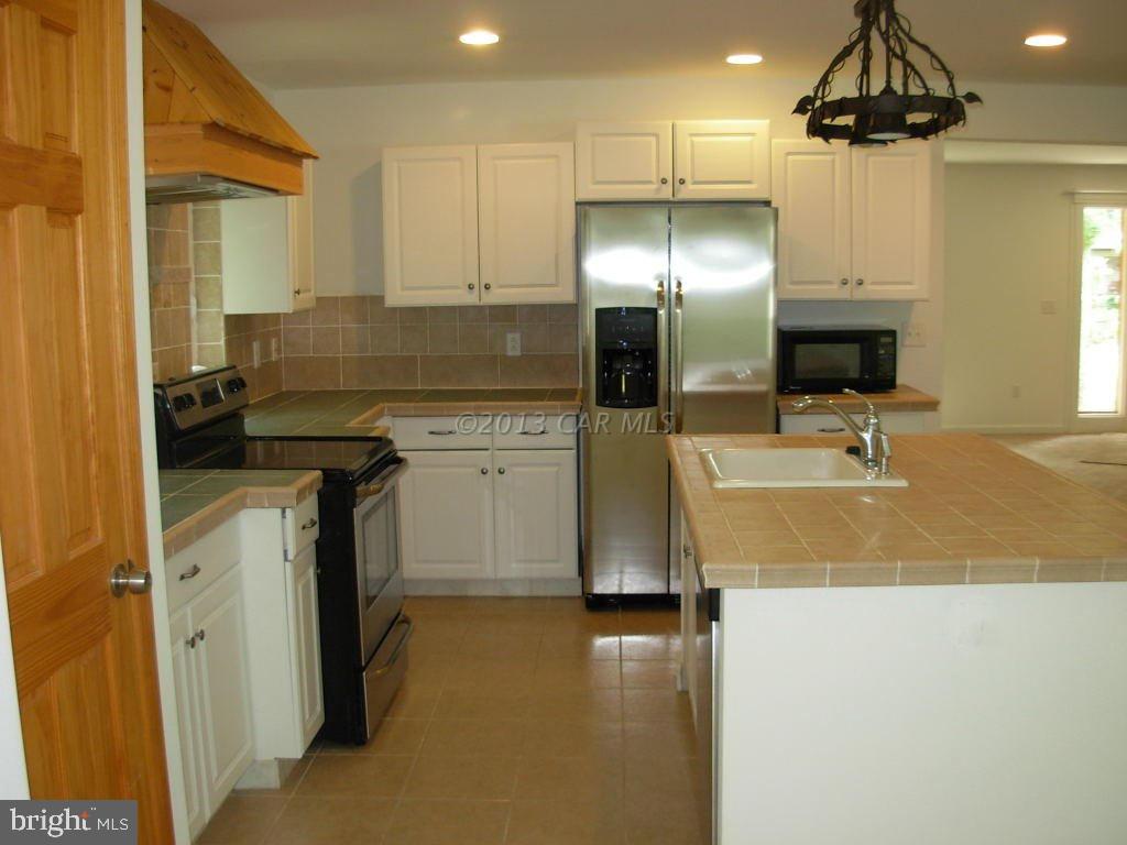 9409 Croppers Island Road Newark, MD 21841 - Photo 9 of 27 a kitchen with a sink appliances and cabinets