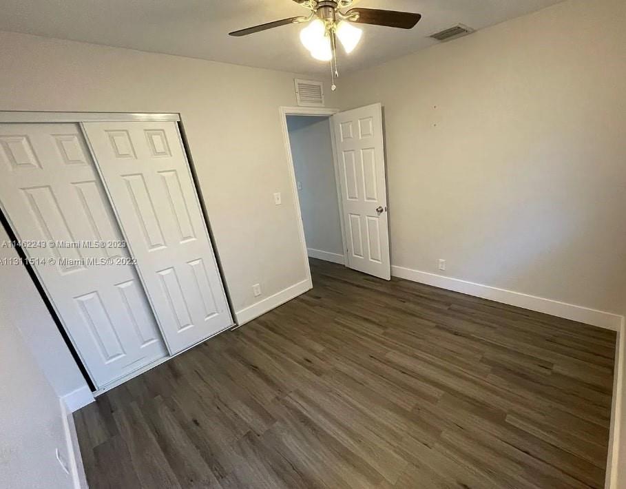 450 Southwest 2nd Street, Unit 4 Pompano Beach, FL 33060 - Photo 3 of 9 a view of a hallway with wooden floor and staircase