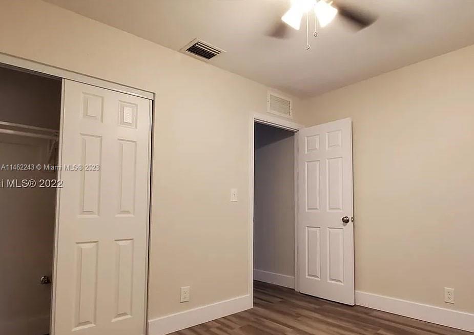 450 Southwest 2nd Street, Unit 4 Pompano Beach, FL 33060 - Photo 5 of 9 a view of a hallway with wooden floor