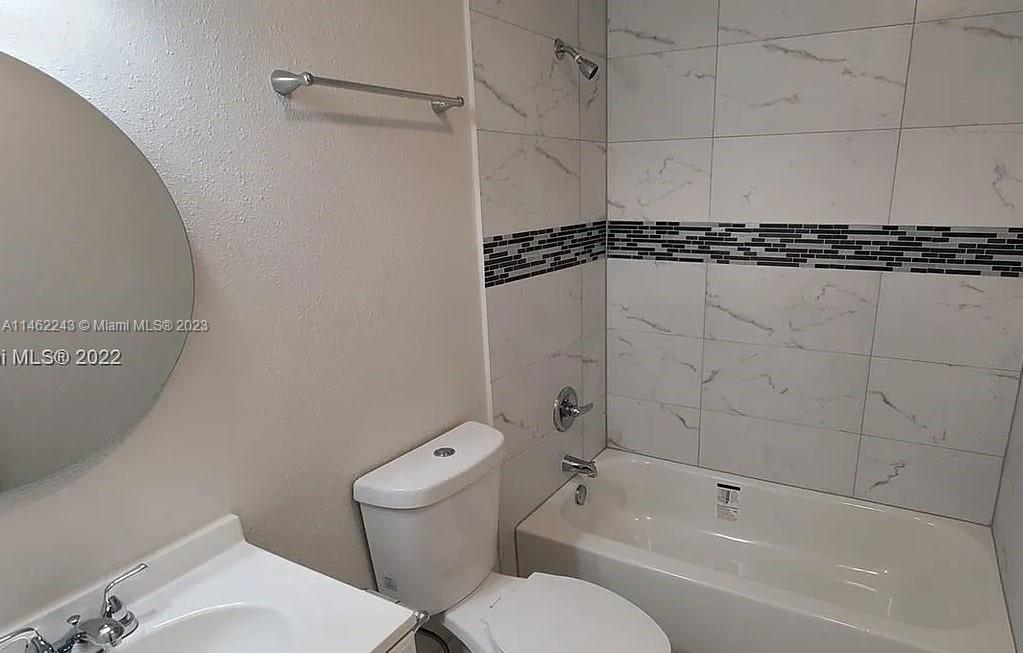 450 Southwest 2nd Street, Unit 4 Pompano Beach, FL 33060 - Photo 8 of 9 a bathroom with a toilet sink and shower
