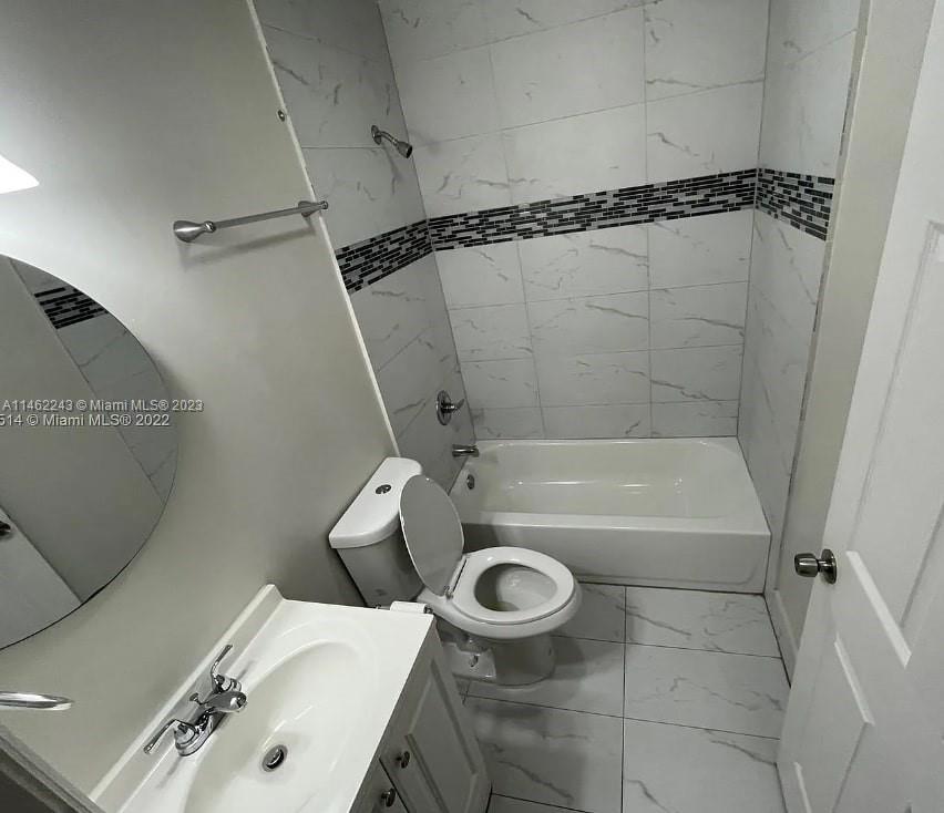 450 Southwest 2nd Street, Unit 4 Pompano Beach, FL 33060 - Photo 9 of 9 a bathroom with a tub a toilet and a shower