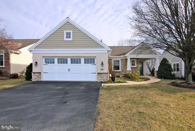 a front view of a house with yard and garage