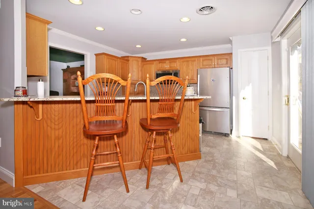 a dining room with furniture a chandelier and wooden floor