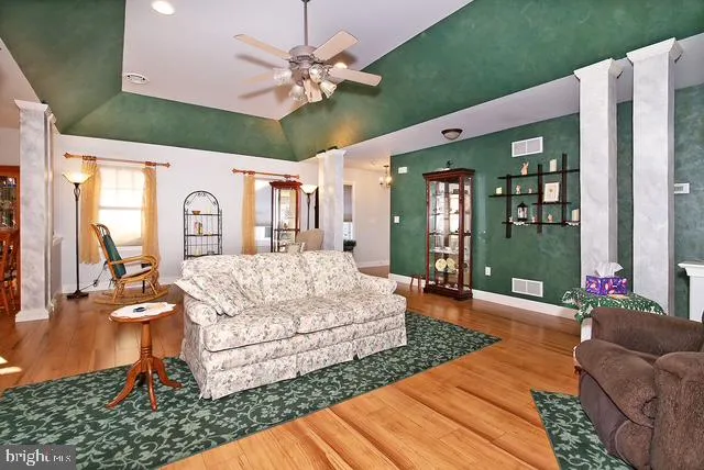 a living room with furniture windows and a flat screen tv