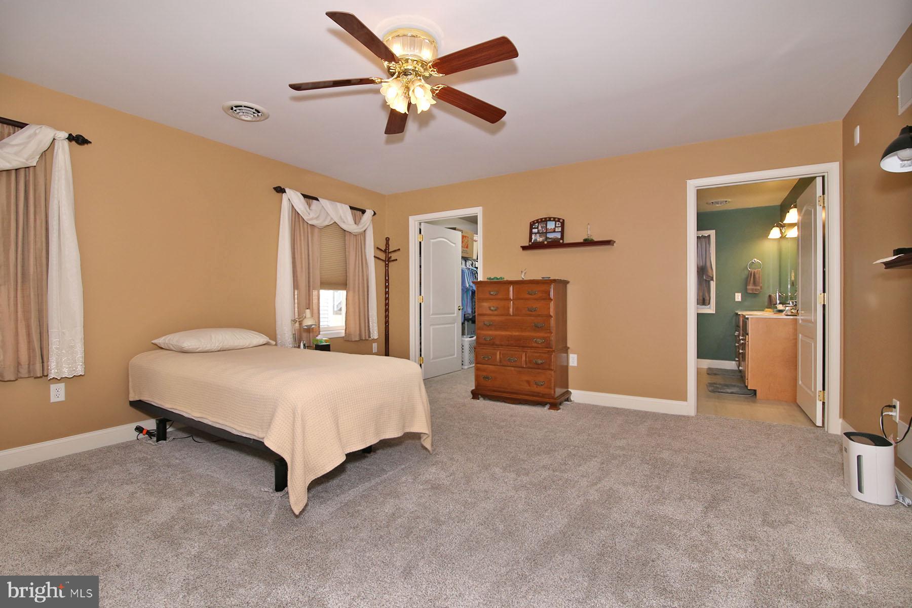 1023 Alden Way Lebanon, PA 17042 - Photo 28 of 74 a spacious bedroom with a bed and a chandelier