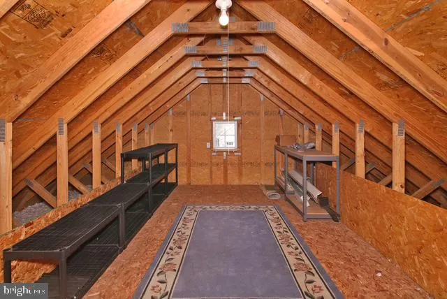 a front view of a house with garden and trees