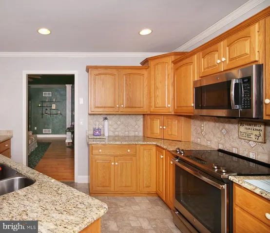 a utility room with granite countertop cabinets washer and dryer