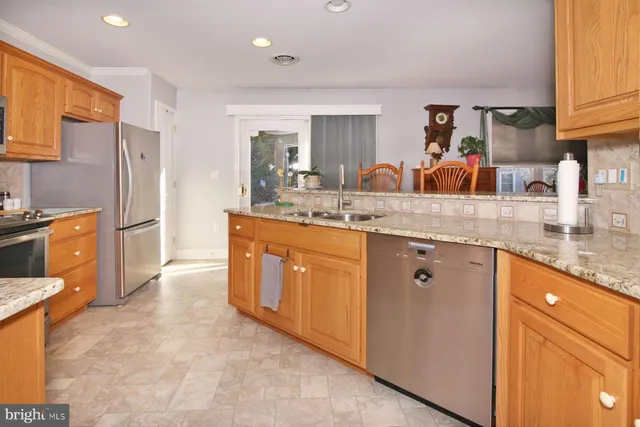 a view of a kitchen with furniture and wooden floor