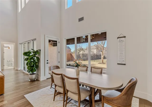 a dining room with furniture window and wooden floor
