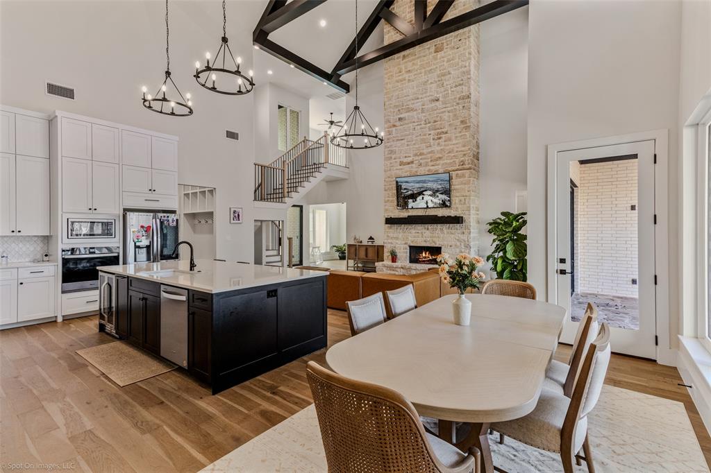7 Center Court Heath, TX 75032 - Photo 12 of 37 a kitchen with stainless steel appliances granite countertop a stove a sink dishwasher and a refrigerator with wooden floor