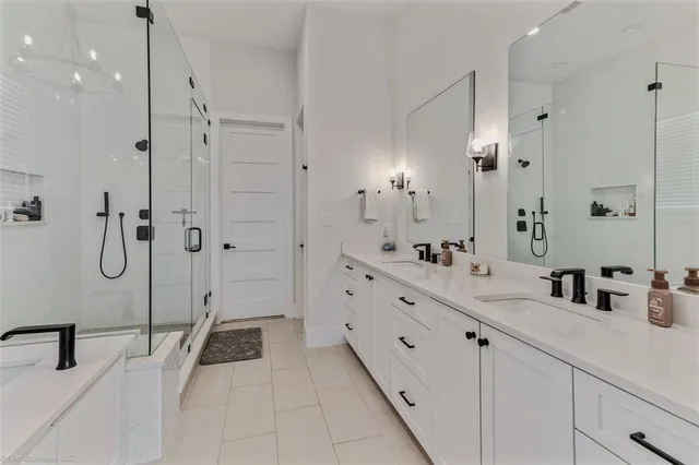 a bathroom with a double vanity sink mirror double and shower