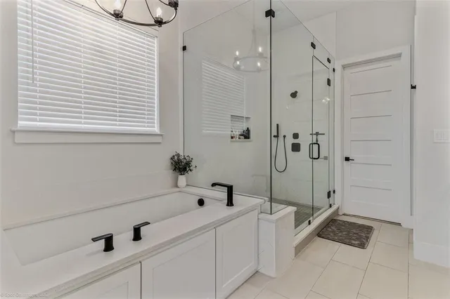 a bathroom with a bathtub and shower