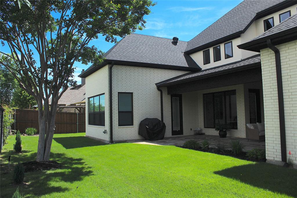 7 Center Court Heath, TX 75032 - Photo 29 of 37 a view of a yard in front of a brick house with a large tree