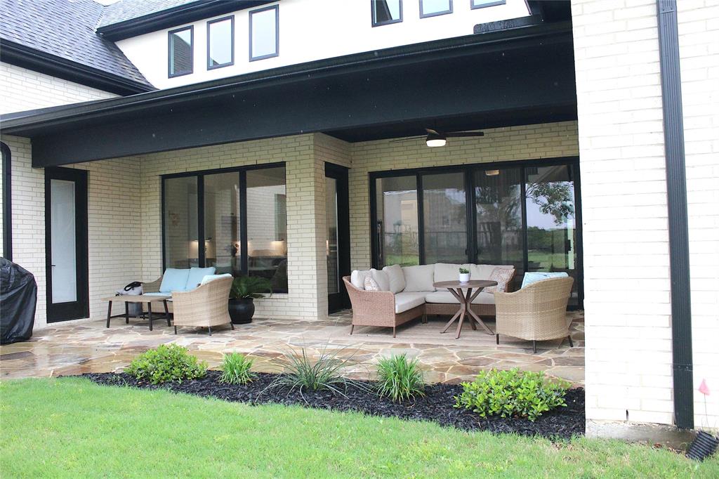 7 Center Court Heath, TX 75032 - Photo 31 of 37 a patio with couches table and chairs and potted plants