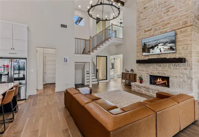 a living room with furniture a flat screen tv and a fireplace