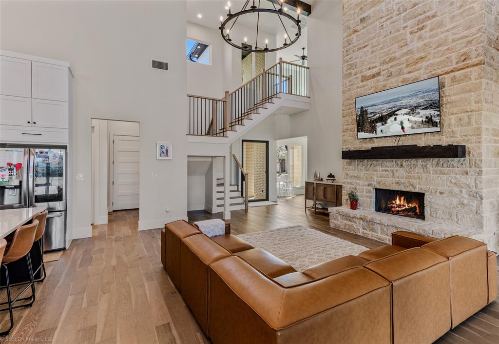 7 Center Court Heath, TX 75032 - Photo 6 of 37 a living room with furniture a flat screen tv and a fireplace