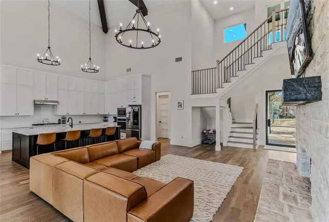 a living room with furniture and a chandelier