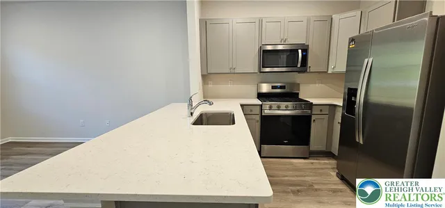a kitchen with a refrigerator and a stove