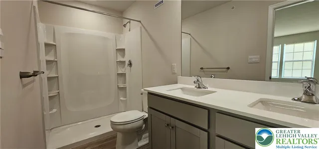 a bathroom with a sink toilet and shower
