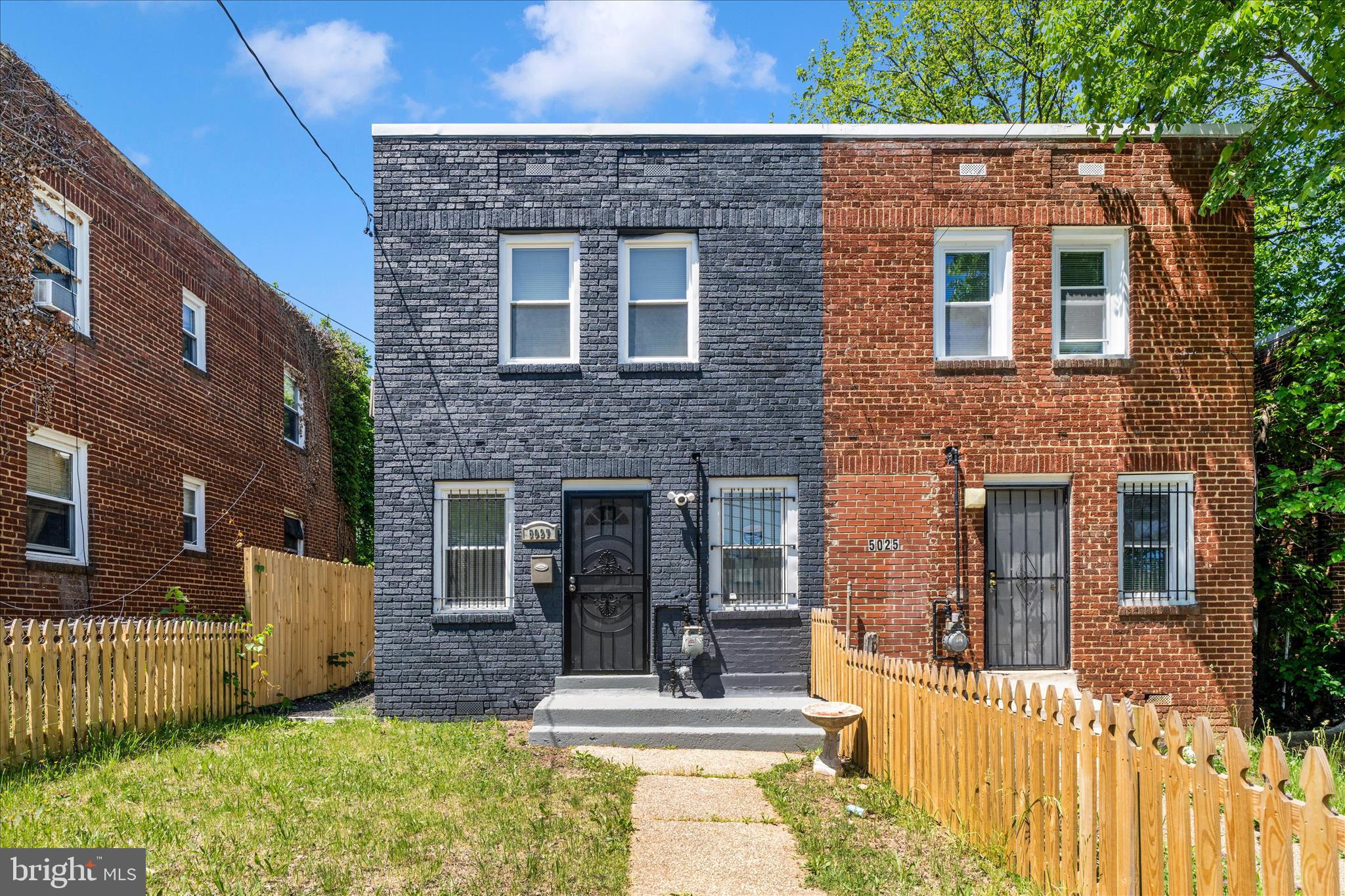5027 Benning Road Southeast Washington, DC 20019 - Photo 1 of 57 a front view of a house with a yard