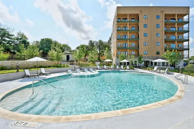 a view of swimming pool with outdoor seating and plants