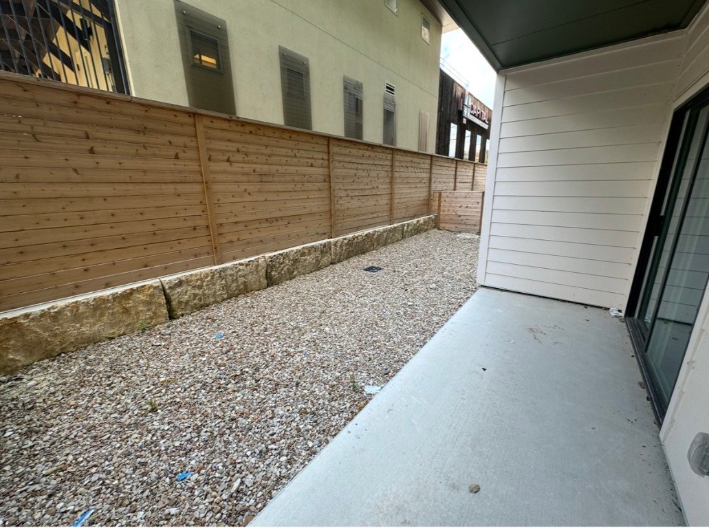 4802 South Congress Avenue, Unit 118 Austin, TX 78745 - Photo 11 of 20 a view of wooden fence and a building