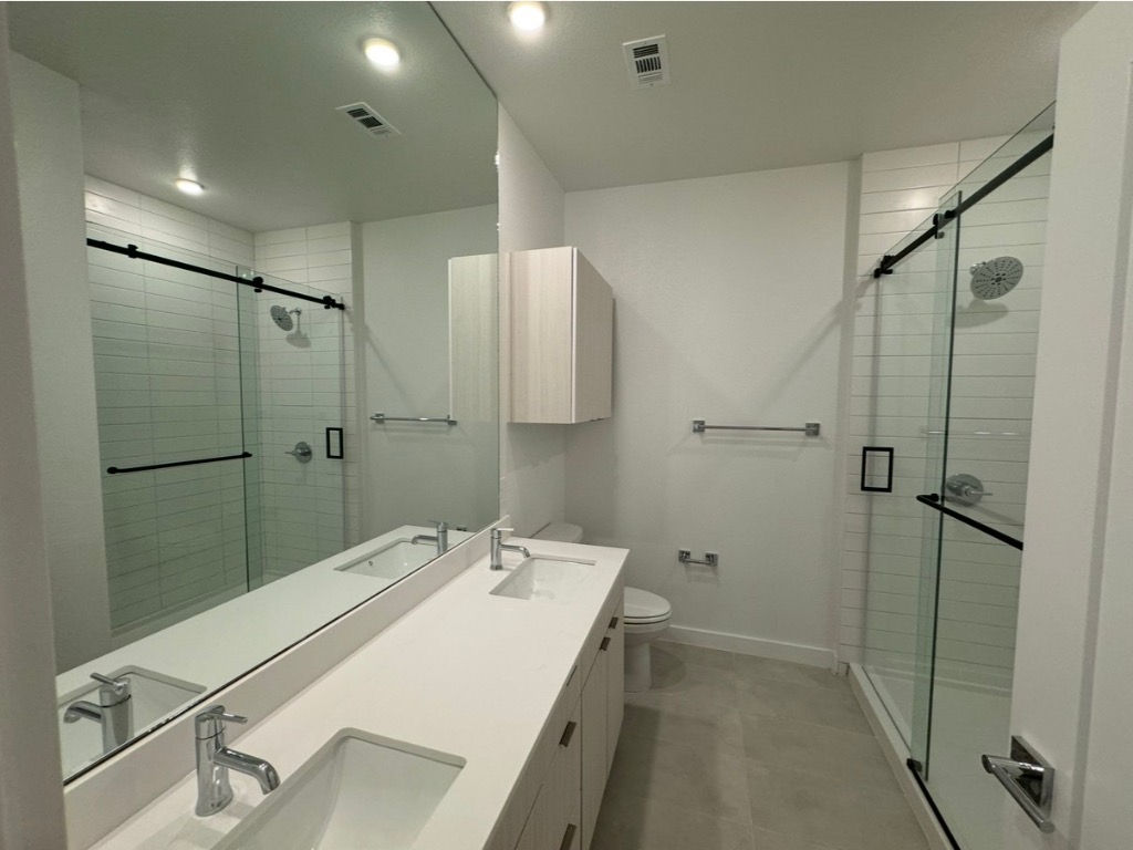 4802 South Congress Avenue, Unit 118 Austin, TX 78745 - Photo 6 of 20 a bathroom with a sink shower and a mirror