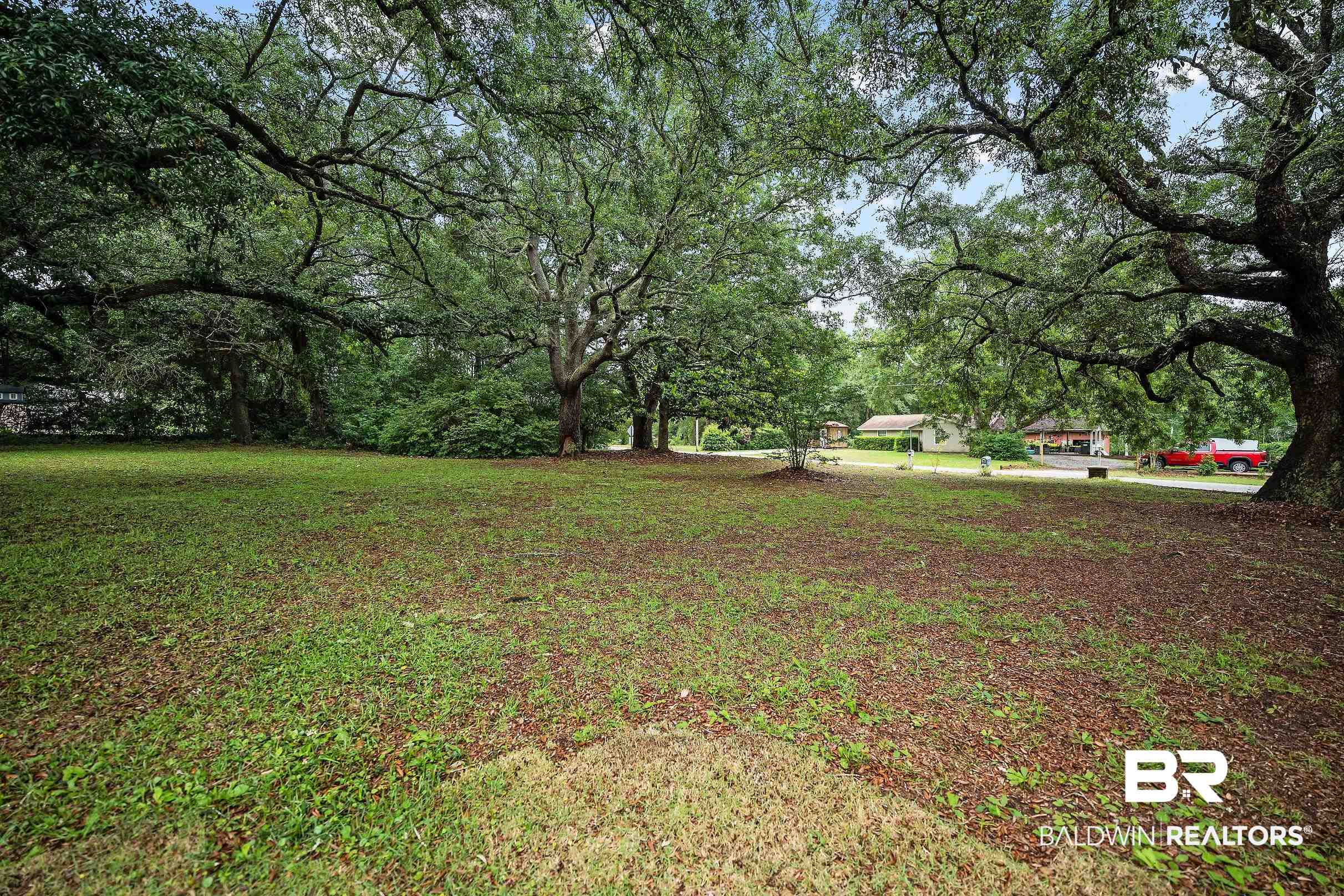 33129 Antietam Road Lillian, AL 36549 - Photo 27 of 31 Expansive green space featuring several mature trees, providing natural shade