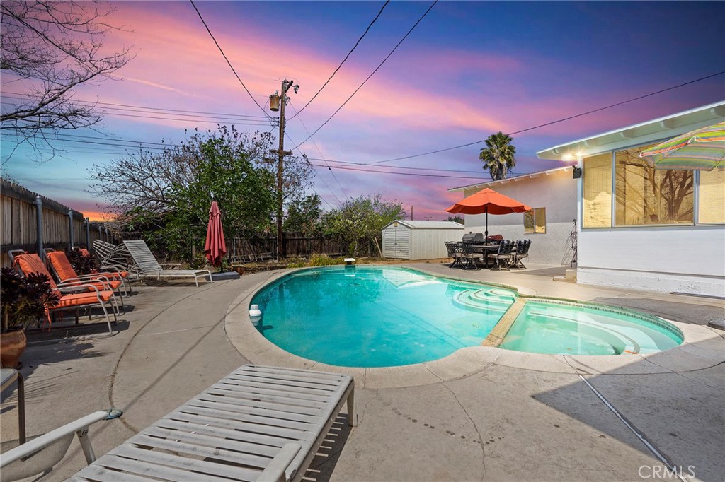 a swimming pool with outdoor seating and yard