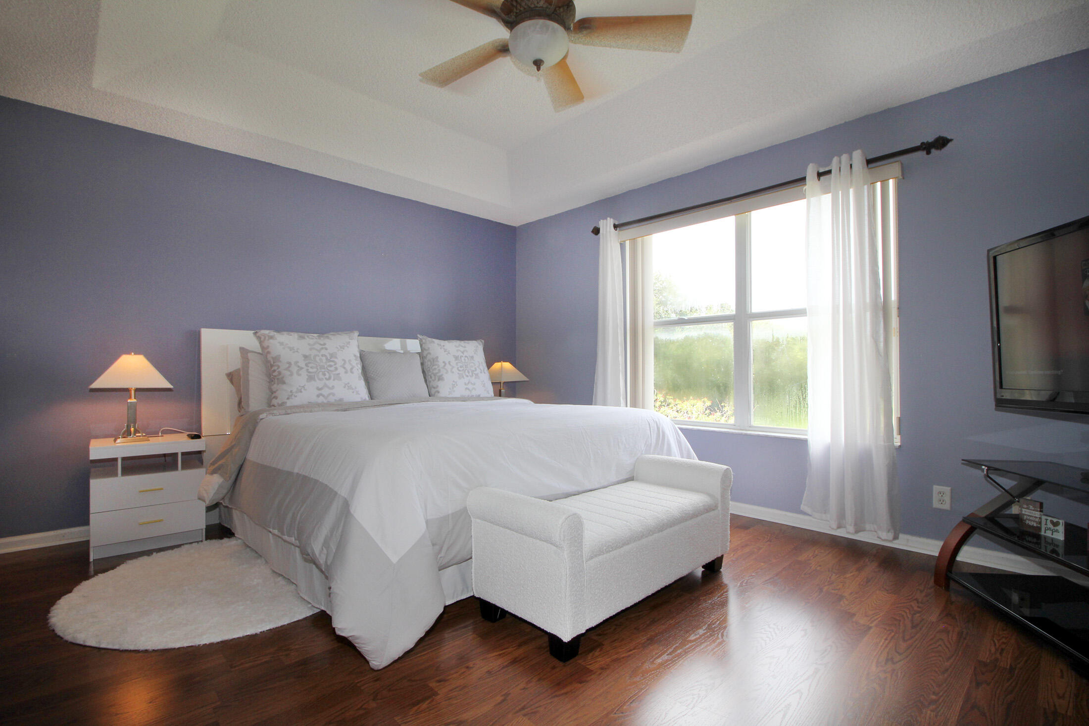 5809 Raceway Road Lake Worth, FL 33449 - Photo 9 of 13 a bedroom with a bed and wooden floor