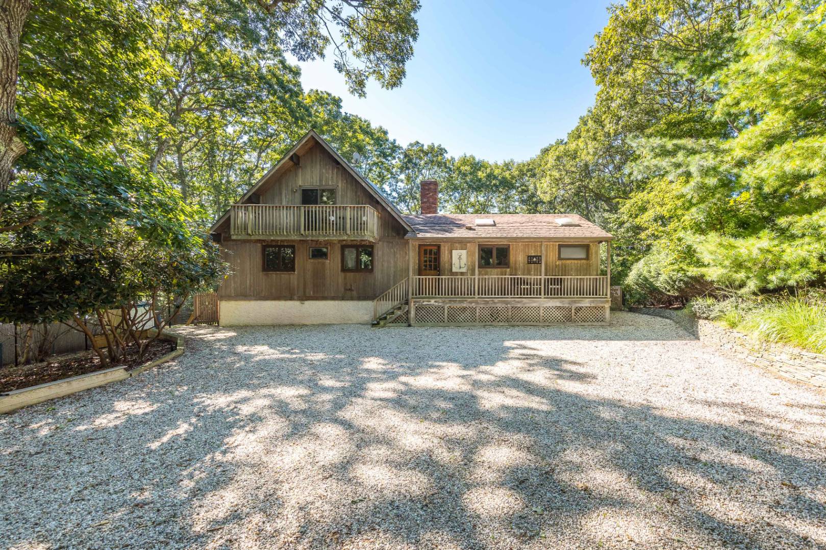 72 Fenmarsh Road East Hampton, NY 11937 - Photo 2 of 20 a front view of a house with a yard and garage